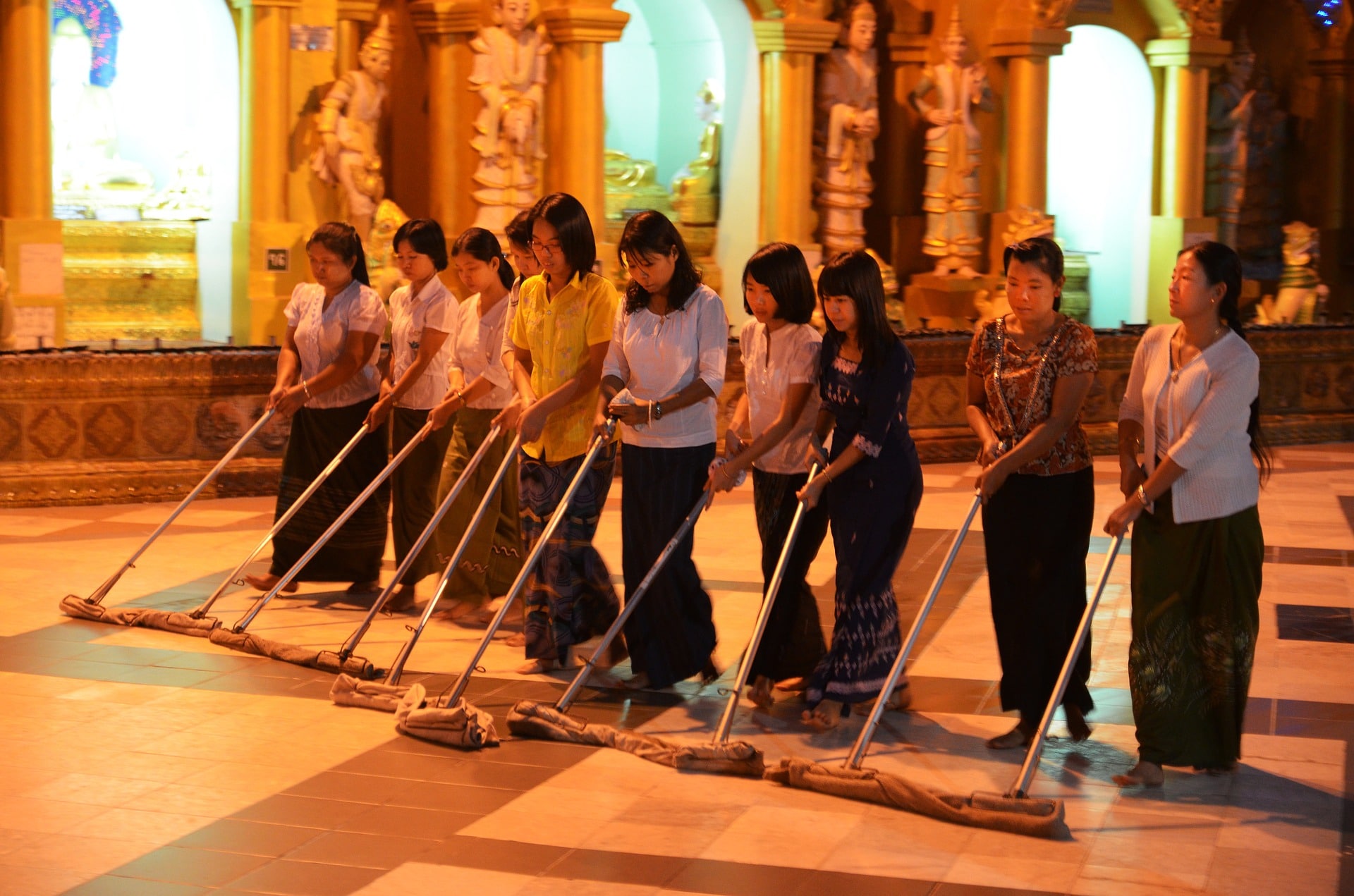 Workers cleaning a floor to earn a small income