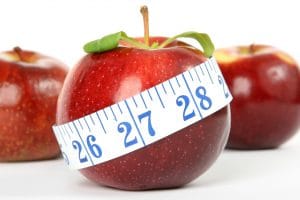 Apple with tape measure indicating it is healthy